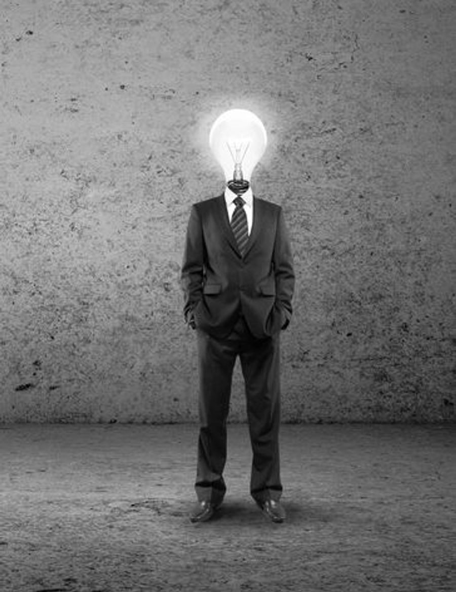 Black-and-white image of a man in a suit with a lightbulb in place of his head, symbolizing ideas and clarity